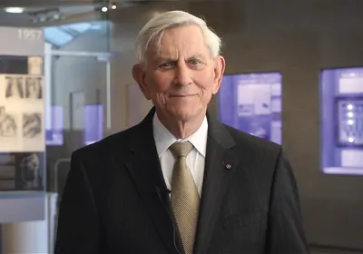 Man in black suit looking at camera